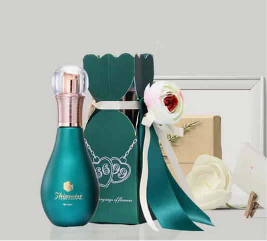 Aromatherapy hair oil in a turquoise bottle with a decorative gift box and floral accents.