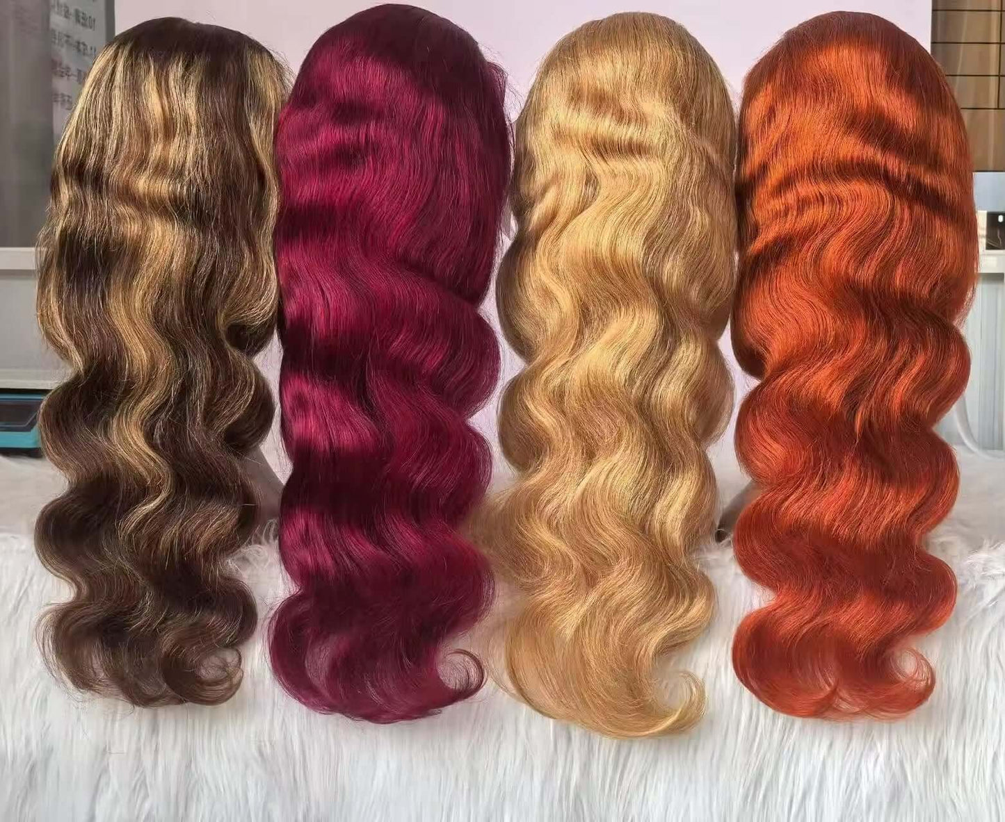 Four premium quality 24 inch lace frontal wigs displayed in various colors with wavy textures