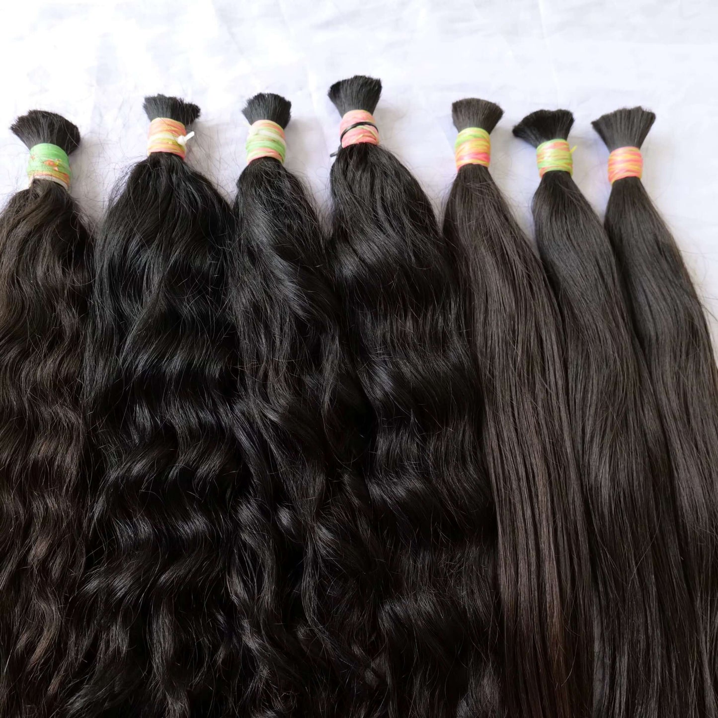 100% Natural Bulk Hair bundles in various textures and lengths, showcasing quality and purity.